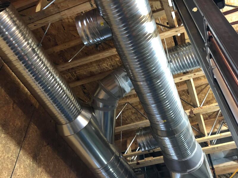 Spiral ductwork installed in building framing